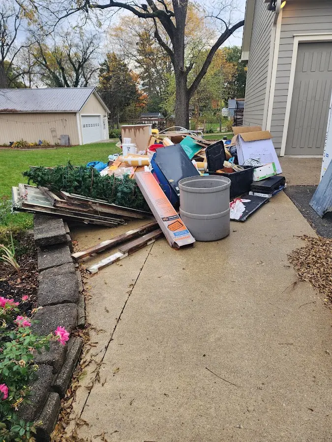 Dumpster being loaded with debris for Estate Cleanout Dumpster Rental in Choctaw